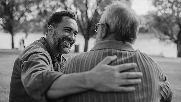 adult son and father talking