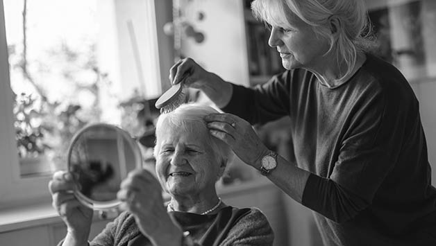 caregiver combs mothers hair