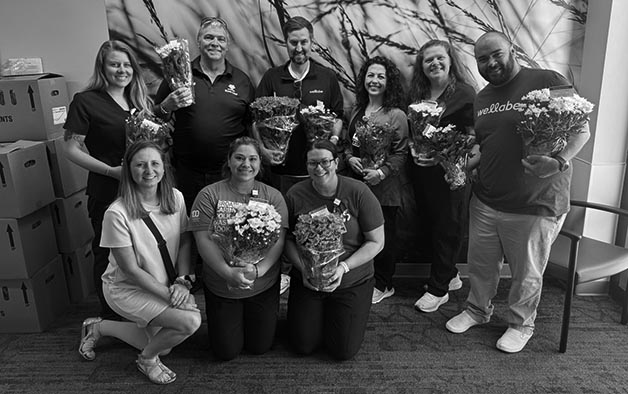 wellabe staff deliverying blooming with hope flowers