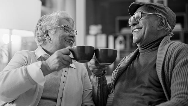 senior couple drinking tea in large mugs