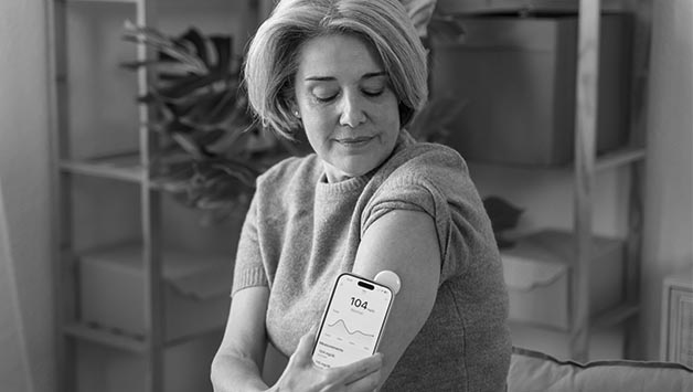 woman using diabetes tech on her arm